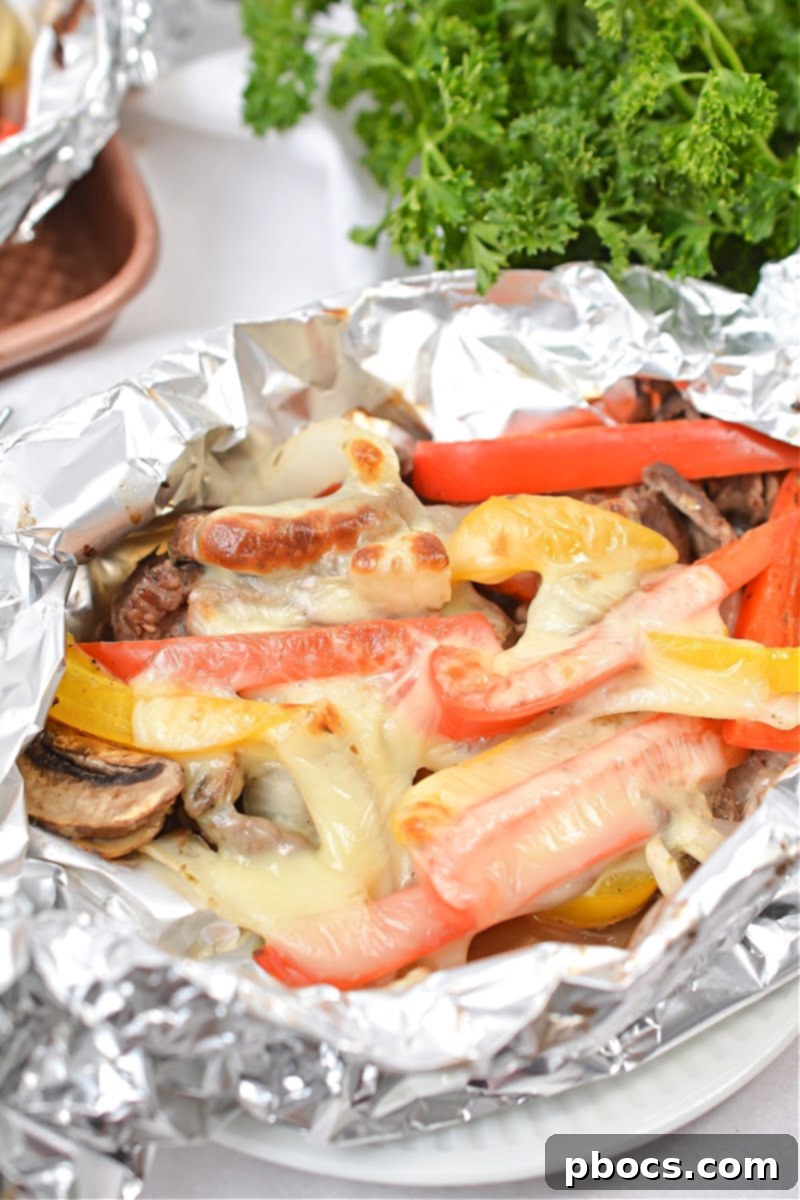 Keto Philly Cheesesteak Foil Packets – Thinly sliced steak, melted cheese, and fresh vegetables cooked to perfection in foil