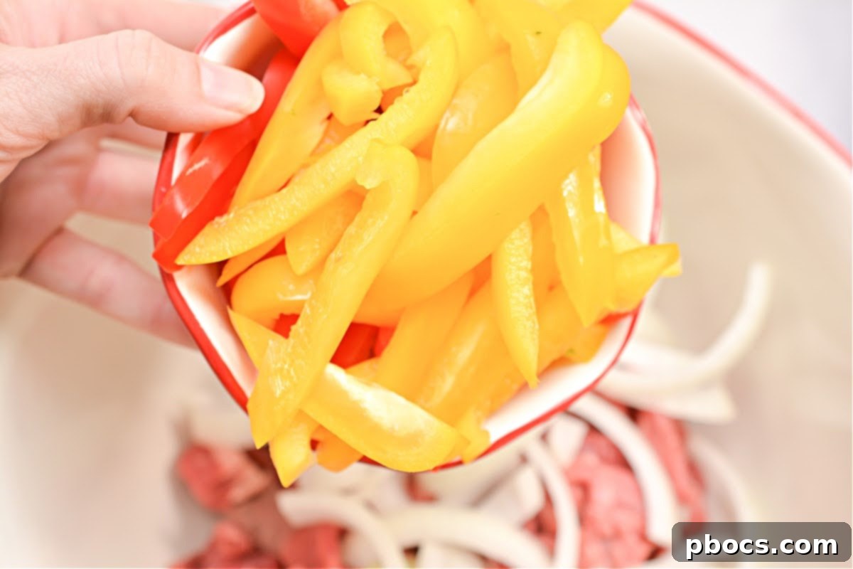 Mixing ingredients for Keto Philly Cheesesteak Foil Packets