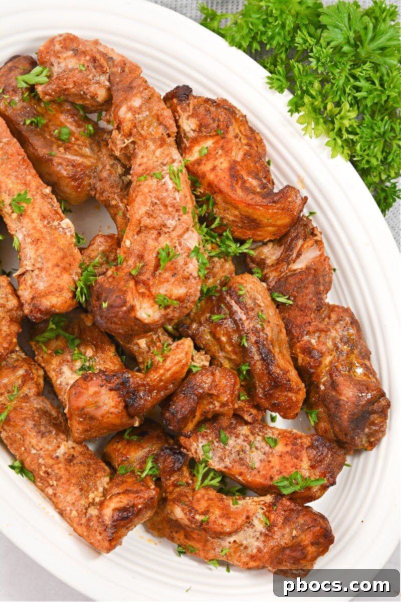 Cajun Keto Oven Ribs 4 Pork ribs coated with dry rub, ready for baking