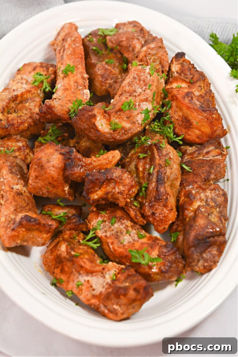 Cajun Keto Oven Ribs 5 Close-up of baked Keto Cajun Pork Ribs glistening with braising liquid