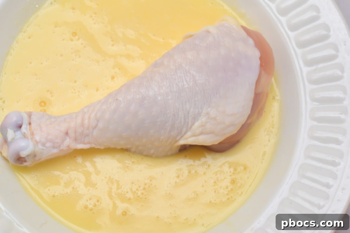 Step 4: Coating chicken with pork rind breading