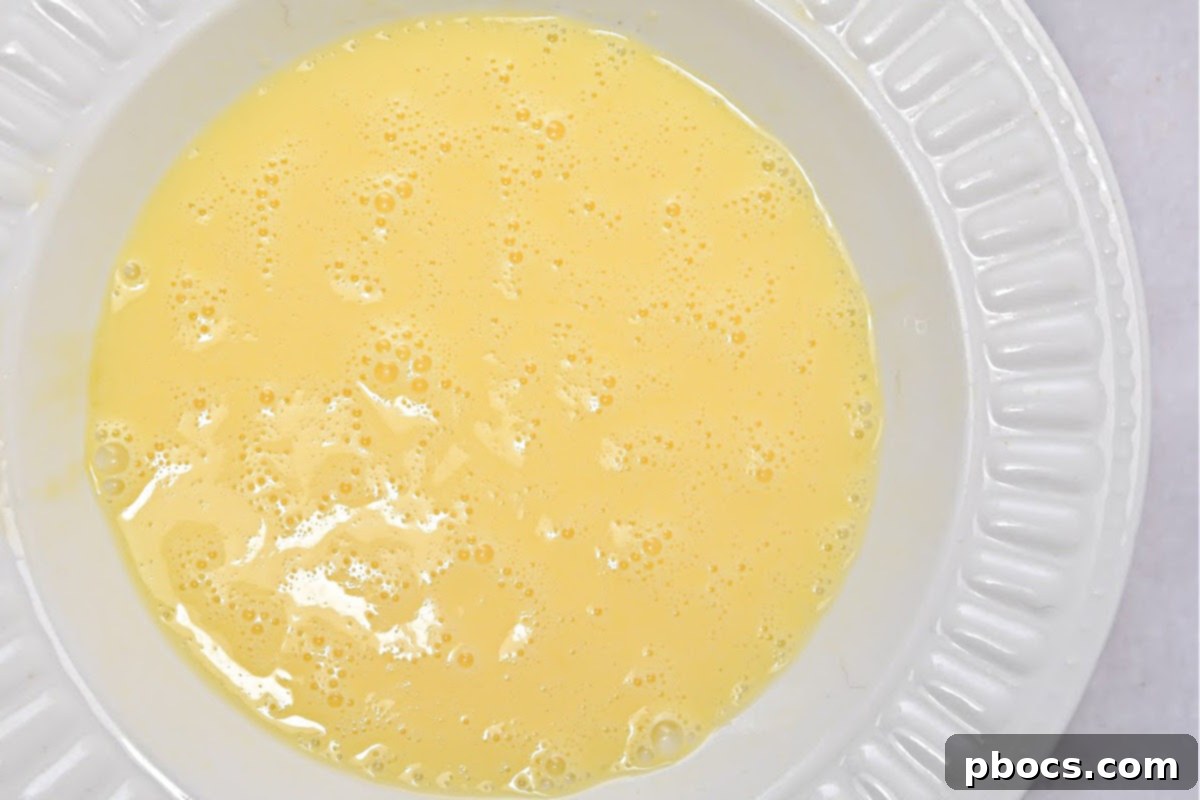 Step 1: Beating eggs and cream for keto fried chicken