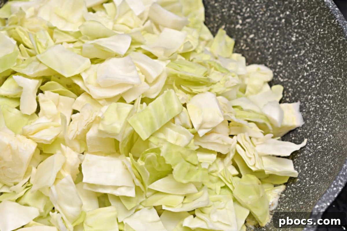 Keto Butter Fried Cabbage With Ground Sausage - Sauteing Garlic