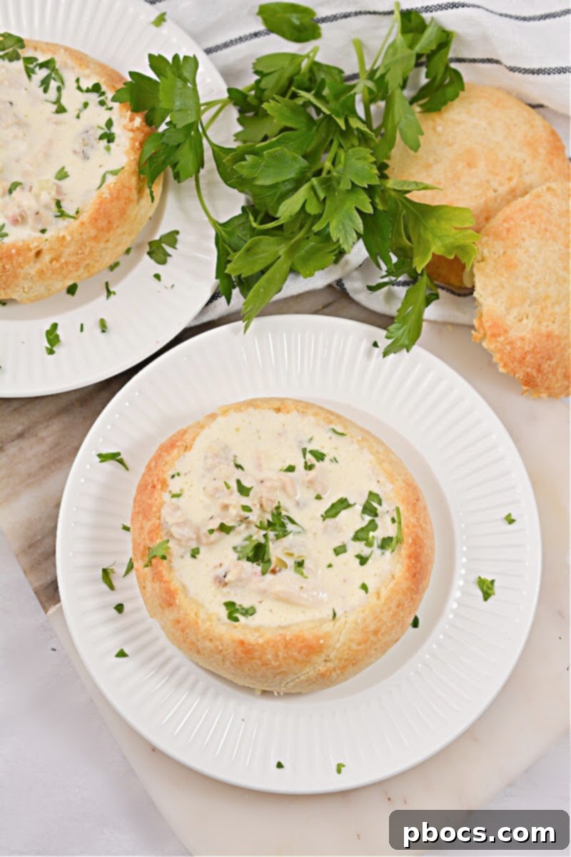 Delicious Keto Bread Bowl filled with creamy Keto Cream of Chicken Soup, garnished and ready to serve.