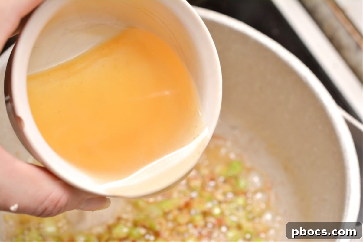 Minced garlic added to celery and butter, sautéing to release its aroma.