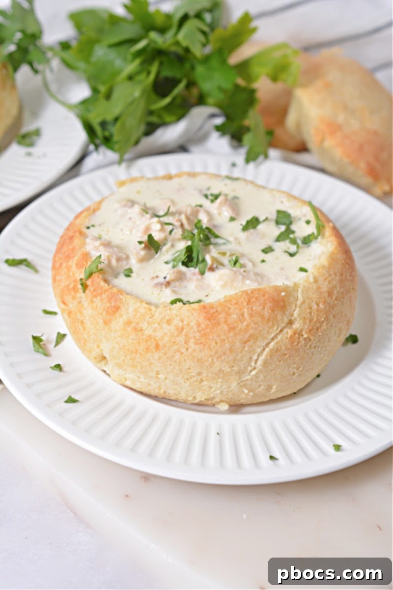 Final presentation of a Keto Bread Bowl filled with Cream of Chicken Soup, ready to serve.