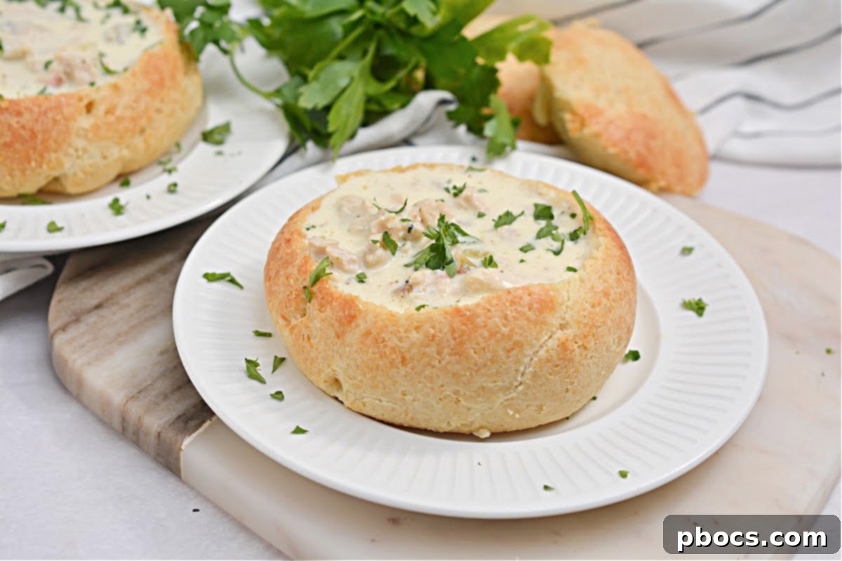 Keto Bread Bowl next to a bowl of creamy soup, highlighting its potential as a versatile low-carb bread.