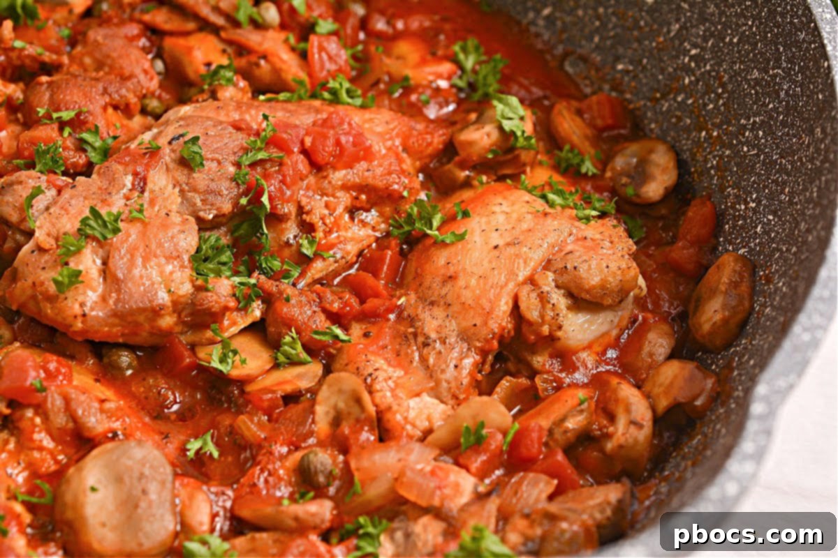 Chicken thighs searing in a cast iron skillet