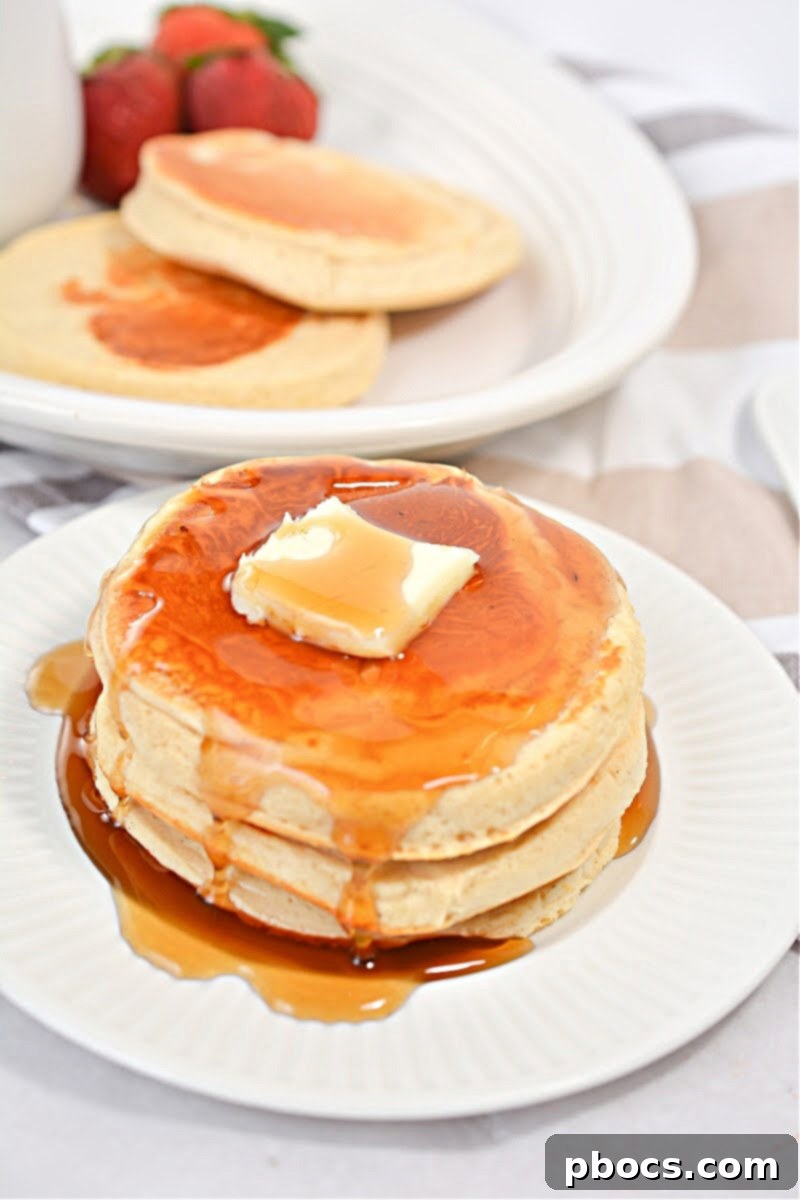 Keto Protein Pancakes Topped with Sugar-Free Syrup and Berries