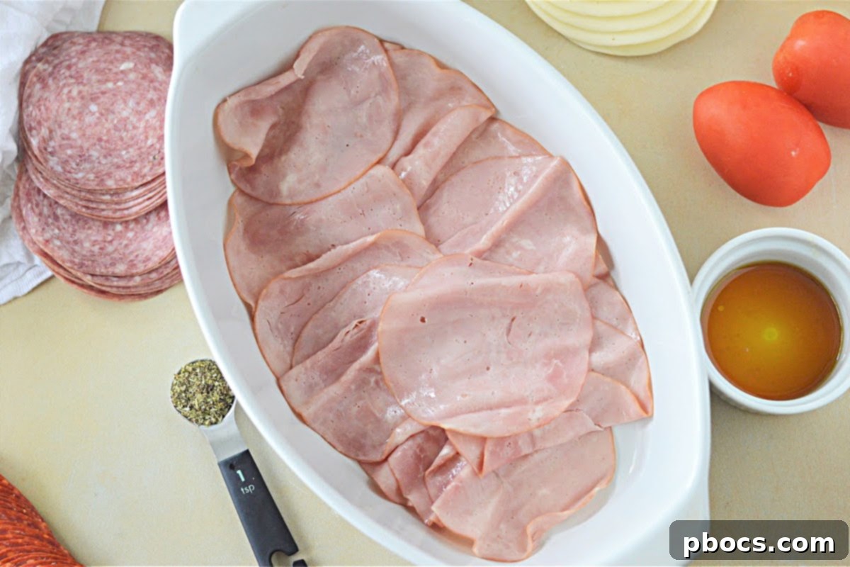 Keto Italian Deli Bake 12 Layering salami over ham