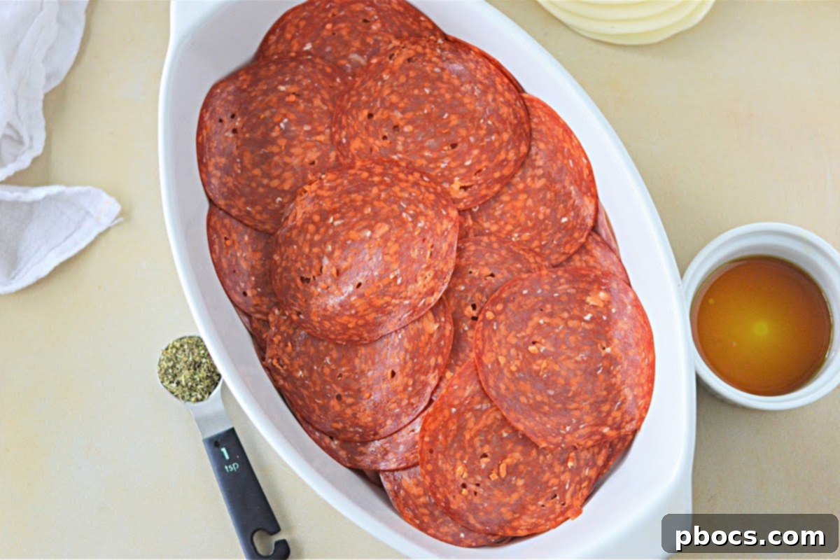 Keto Italian Deli Bake 14 Adding sliced tomatoes to the meat layers