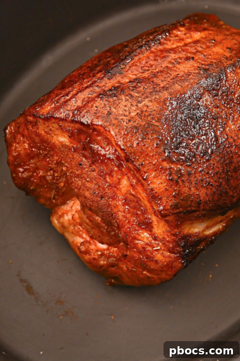 Applying keto brown sugar rub to pork shoulder