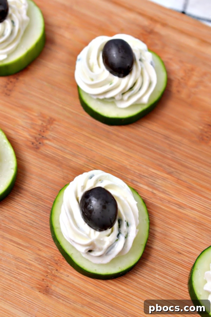 Keto Cucumber Web Bites 12 Step 5: Piping cream cheese mixture onto individual cucumber slices