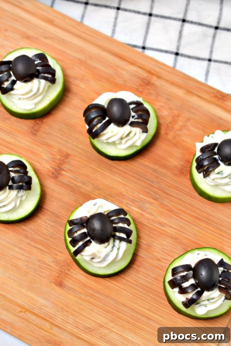 Keto Cucumber Web Bites 5 Fresh cucumber slices arranged on a cutting board, ready for appetizer topping