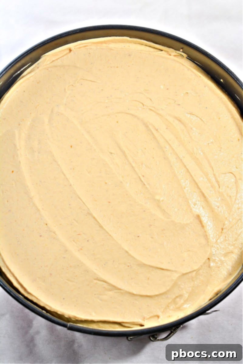 Keto Pumpkin Spice Mousse Cake 13 Step 6: Spreading pumpkin mousse over crust