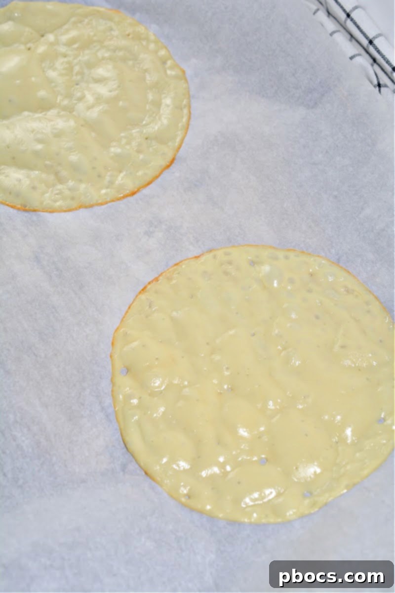 Keto Club Pinwheels 9 Keto Club Sandwich Roll Ups - Spreading mayonnaise on warm cheese wrap.