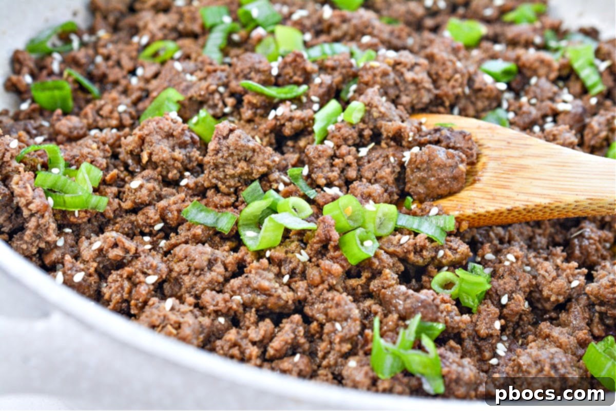 Serving Keto Korean Beef Bowl over cauliflower rice with garnishes