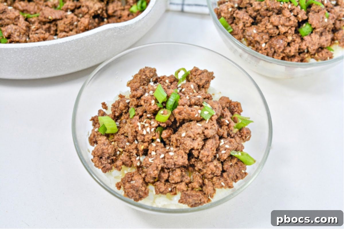 Overhead view of a Keto Korean Beef Bowl, artfully garnished with green onions and sesame seeds