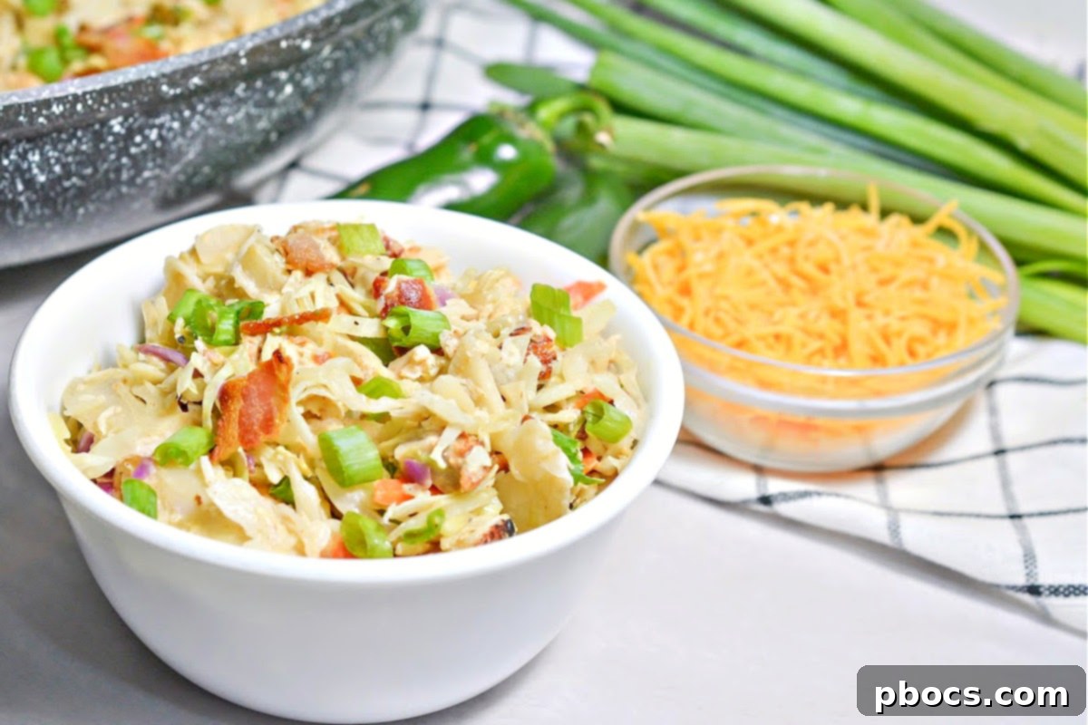 Close-up of Keto Crack Slaw, showing shredded chicken, jalapenos, and melted cheese mixed with cabbage.
