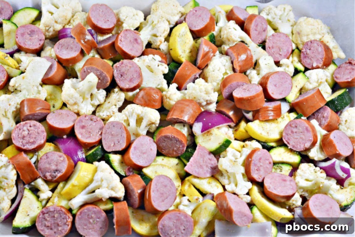 Low-Carb Sheet Pan Sausage and Veggies - Vegetables spread evenly on a baking sheet