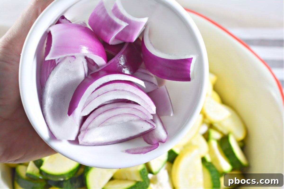 Low-Carb Sheet Pan Sausage and Veggies - Vegetables in a bowl with olive oil