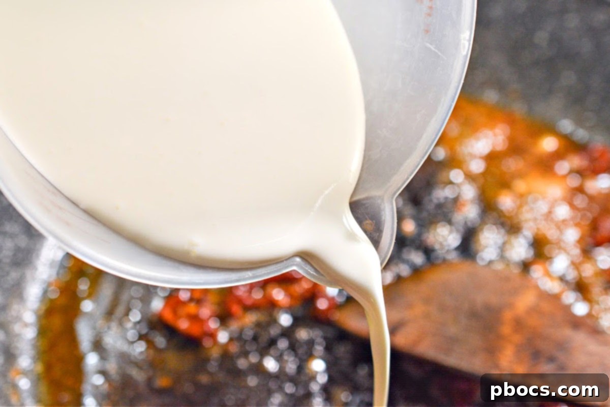 Creamy Tomato Basil Keto Chicken Skillet 15 Tomato basil cream sauce simmering and thickening in the skillet