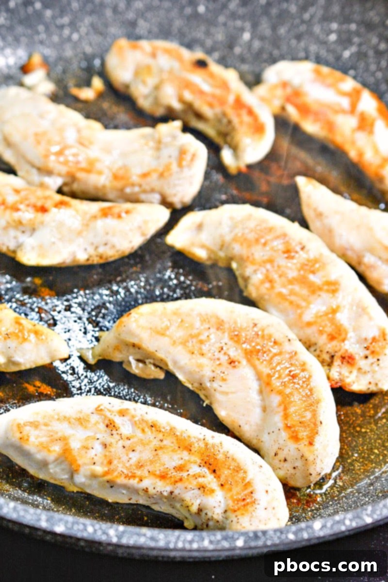 Creamy Tomato Basil Keto Chicken Skillet 9 Olive oil heating in a skillet