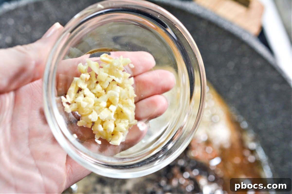 Creamy Tomato Basil Keto Chicken Skillet 11 Butter melting in the skillet after chicken has been removed
