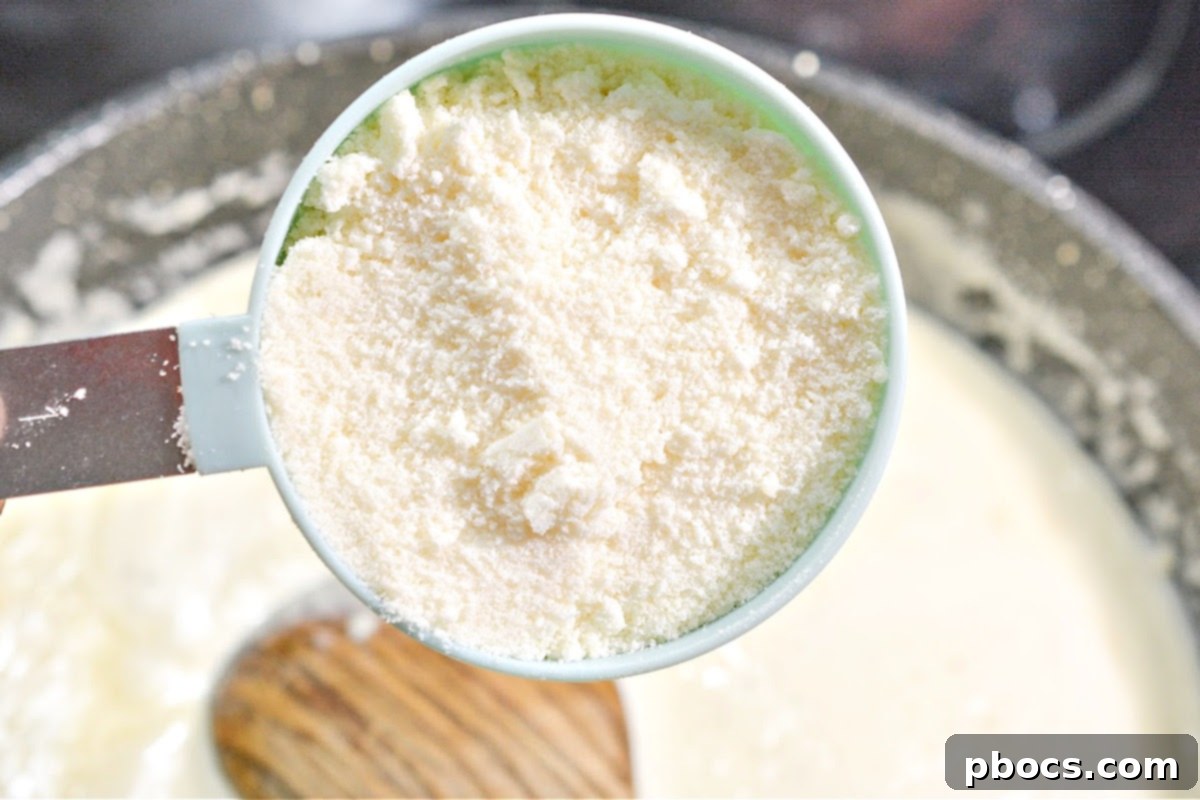 Kentucky Hot Brown Keto Bake 14 Adding Parmesan Cheese to the Sauce