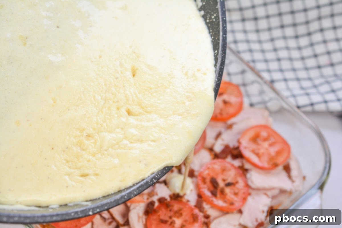 Kentucky Hot Brown Keto Bake 16 Pouring Cheese Sauce Over the Casserole