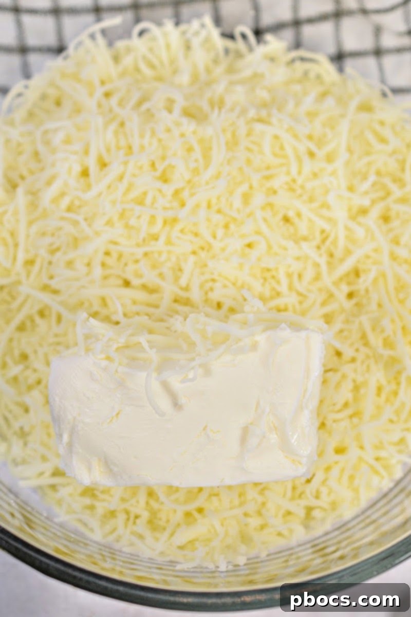 Kentucky Hot Brown Keto Bake 8 Prep Time: 25 minutes Cook Time: 35 minutes Servings: 8 Net Carbs: 5 net carbs per serving Ingredients: For the bread layer: 2 C. Mozzarella cheese shredded 2 oz. Cream cheese 1 ¼ C. Almond flour 1 Large egg ¼ tsp. Xanthan gum 1 tsp. Baking powder ¼ tsp. Garlic powder For the topping: 1 lb. Sliced cooked turkey breast ½ C. Crumbled bacon 2 Roma tomatoes sliced thinly For the sauce 1 ½ C. Heavy whipping cream ¼ C. Chicken broth 1 C. Parmesan cheese grated 2 Tbsp. Butter Salt and pepper to taste Instructions: Heat the oven to 350 degrees, and grease a 9x13 baking dish well. Place the cream cheese and mozzarella cheese into a bowl that is microwave safe. Heat the cheeses at 30 second intervals until melted and combined well. Add the cheese mixture to a mixing bowl with the rest of the bread layer ingredients, and blend until smooth. Press the dough mixture into the bottom of the baking dish and bake for 20 minutes. While the bread layer is baking, melt the butter in a skillet over medium heat. Stir in the heavy whipping cream, broth and salt and pepper to taste. Simmer until the sauce thickens. Stir in the Parmesan cheese and remove from the heat. When the bread layer is done baking, add the turkey breast on top of it, followed by ½ of the crumbled bacon and the tomato slices. Pour the sauce mixture over the casserole, and top with the remaining crumbled bacon. Bake for 15 minutes. Allow to sit for 10 minutes before serving.