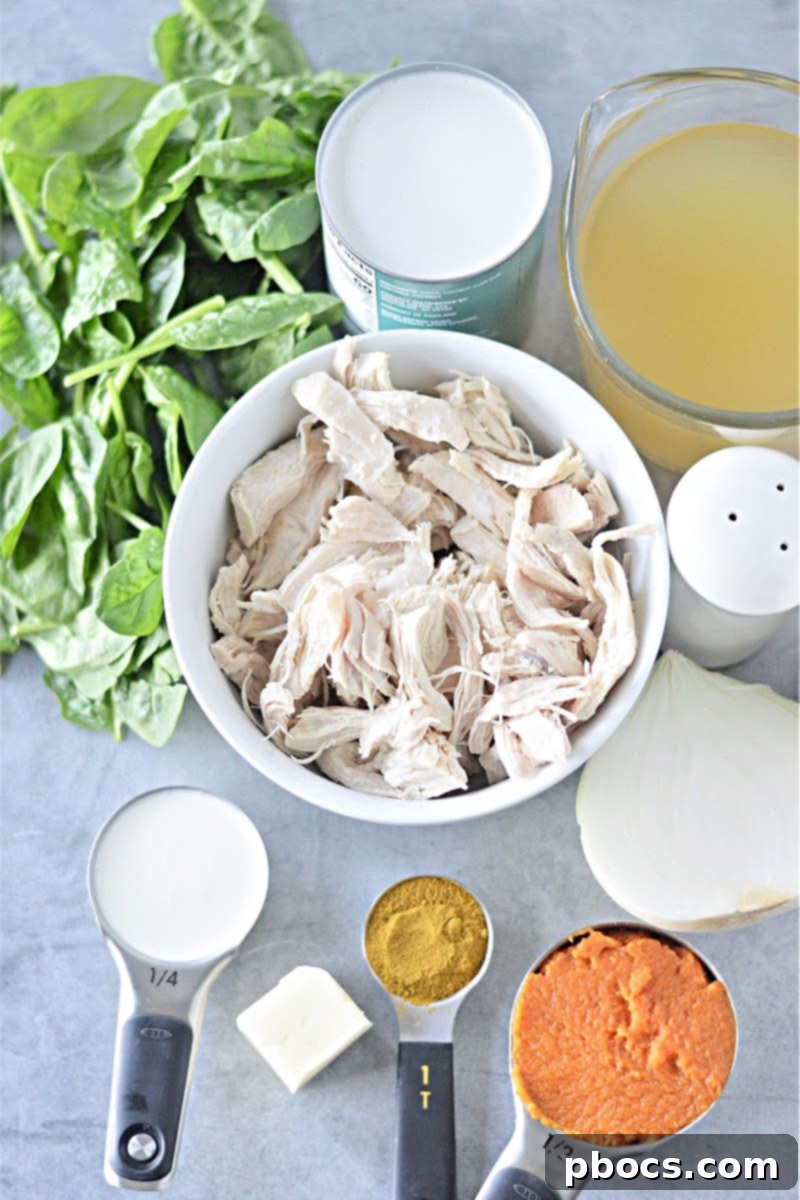 Fresh spinach being added to Creamy Keto Pumpkin Curry Soup for added nutrients