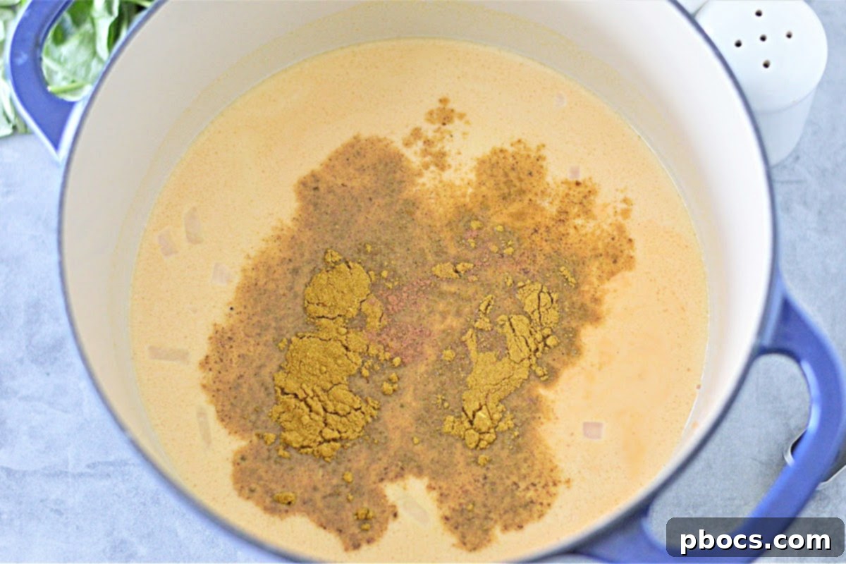 Mixing pumpkin puree and coconut milk for creamy keto pumpkin curry soup