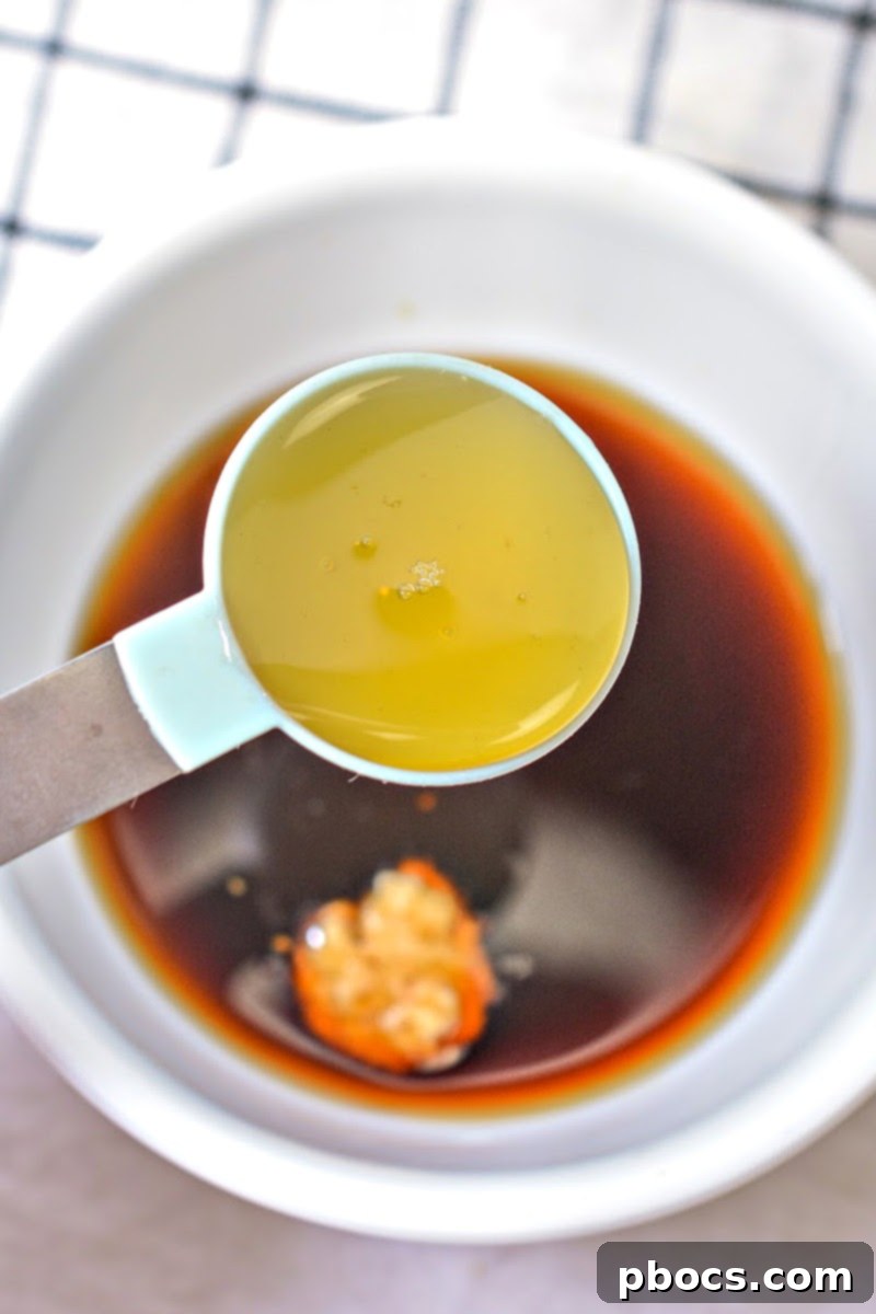 Mixing the low carb chow mein sauce ingredients in a bowl.