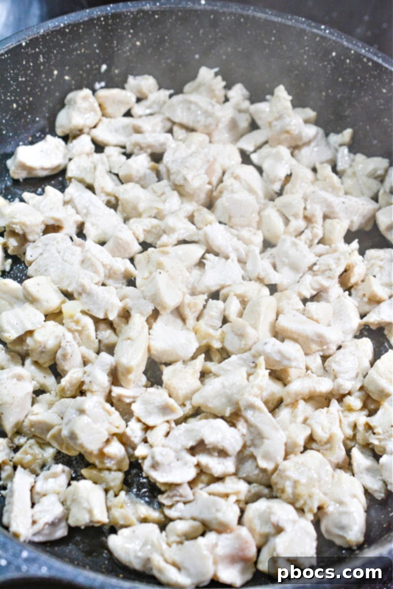 Adding sesame oil to a hot skillet for stir-frying.