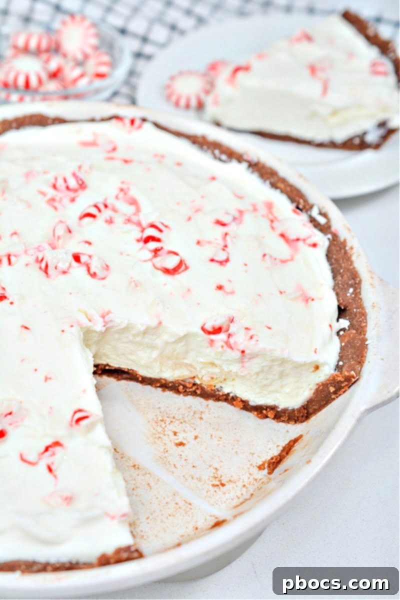 Slice of Keto Candy Cane Cheesecake on a white plate