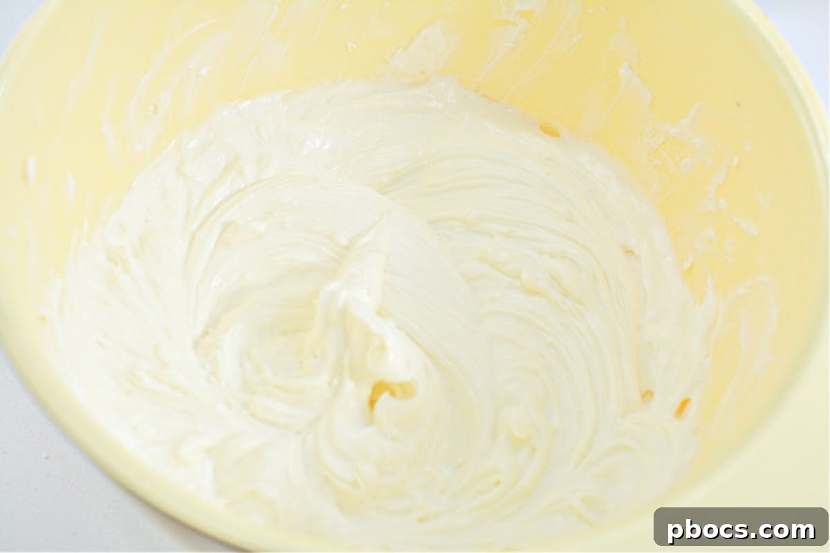 Heavy whipping cream being beaten to stiff peaks