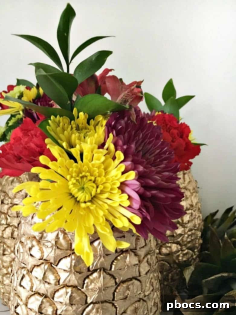 A collection of DIY Pineapple Vases, beautifully arranged as tropical table decor.