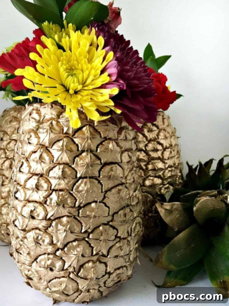 A close-up of a DIY pineapple vase, highlighting the intricate floral arrangement.