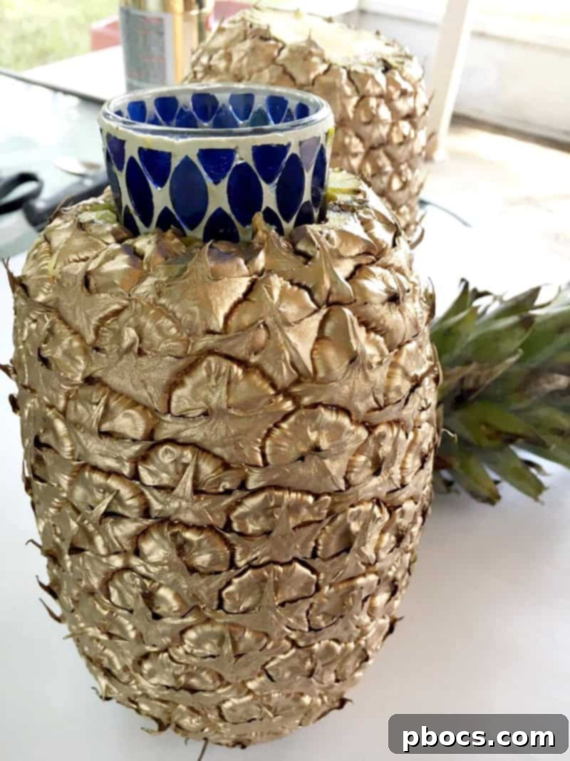 Hollowing out a pineapple and inserting a votive jar for a DIY vase.