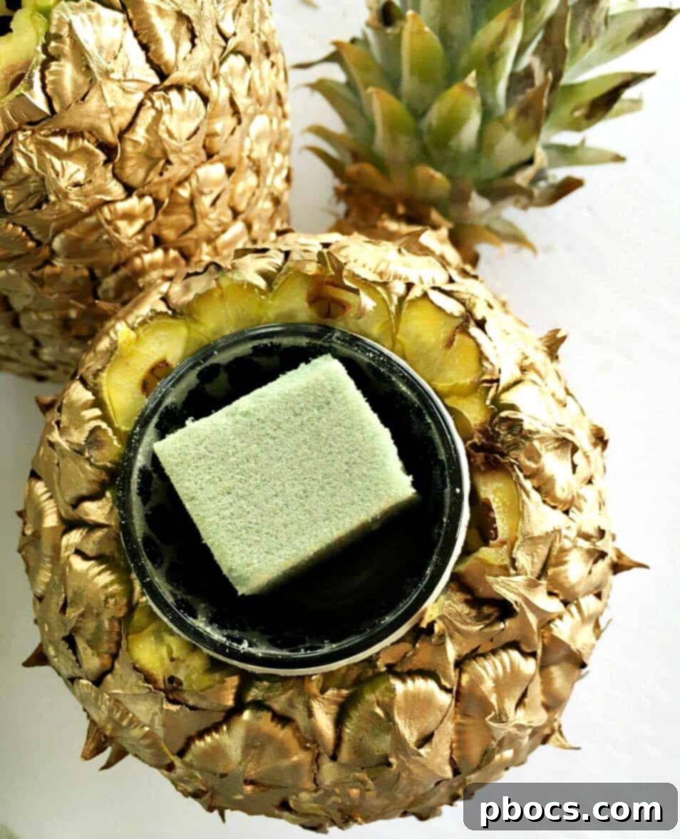 Arranging fresh flowers into a DIY pineapple vase with floral foam.