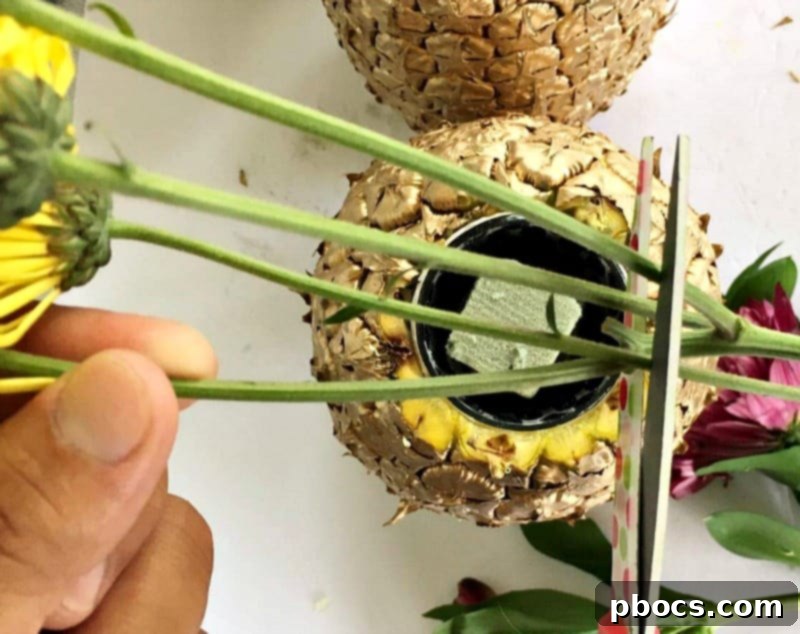 Detail shot of vibrant flowers arranged in a DIY pineapple vase centerpiece.