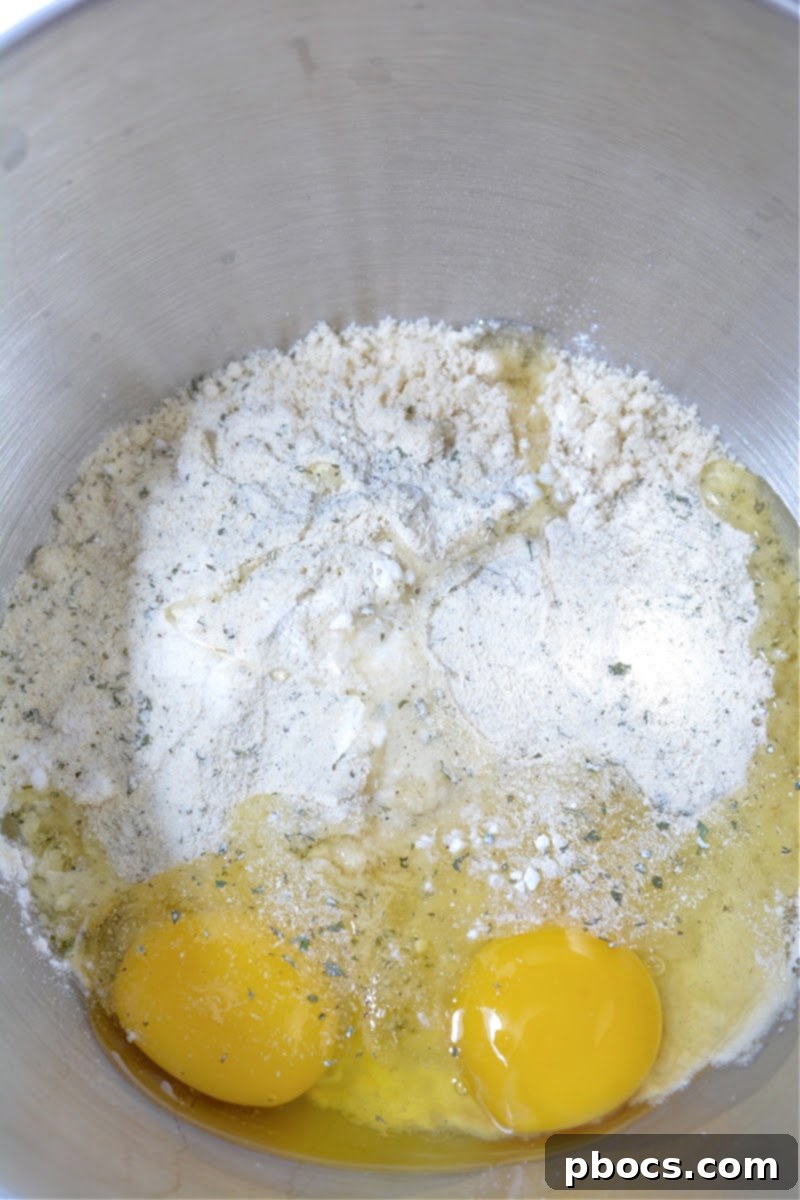 Keto Crave Biscuits 9 Keto Crack Biscuits - Step 2: Mixing the melted cheese with other dry ingredients and eggs.