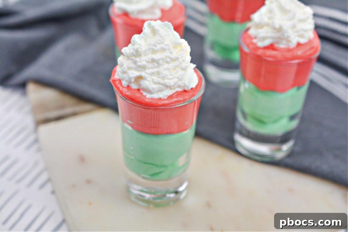Decadent Keto White Chocolate Christmas Shooters 3 Close-up of a festive Keto White Chocolate Christmas Shooter, showing layers of red and green cream.