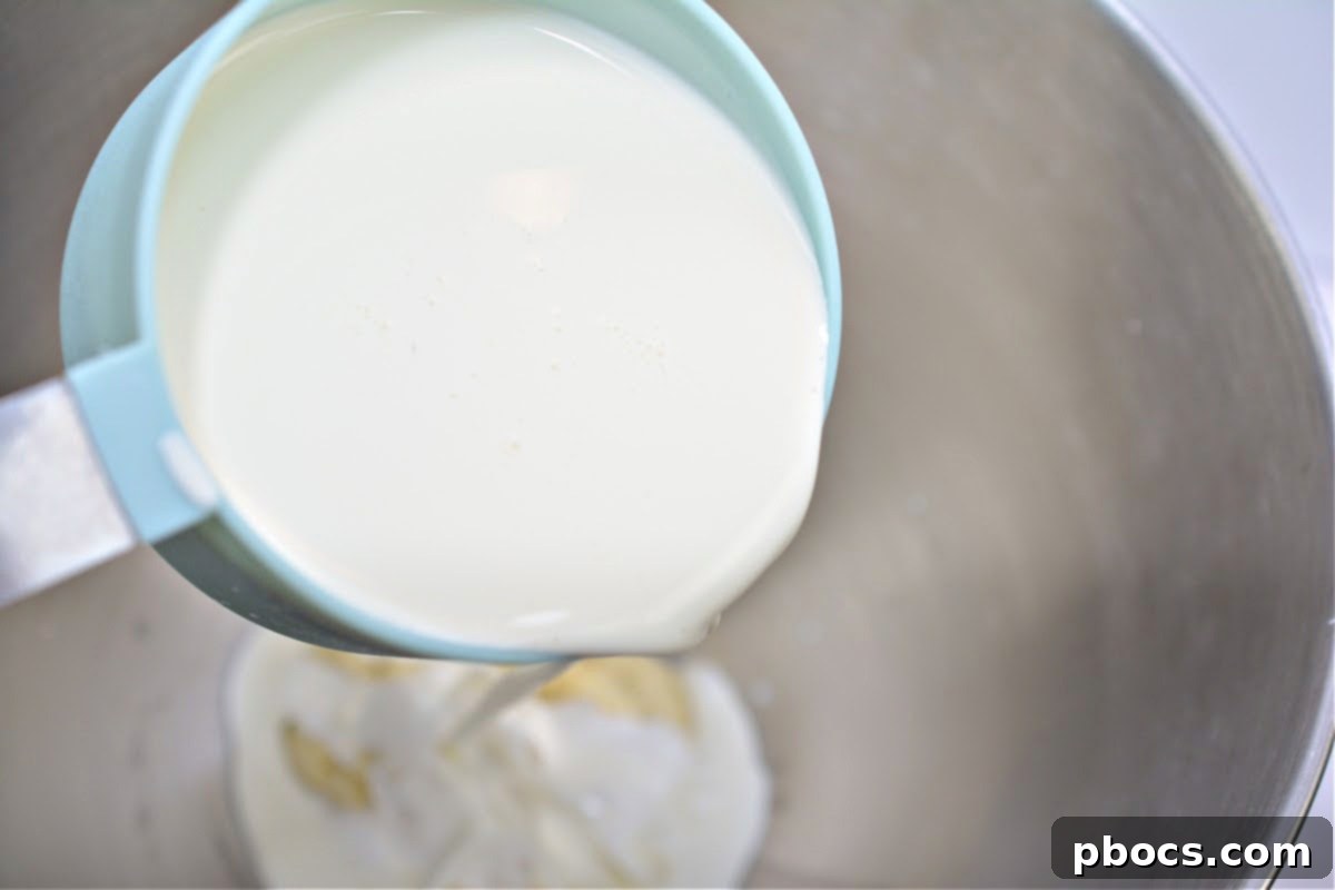 Decadent Keto White Chocolate Christmas Shooters 10 Blending melted chocolate with heavy whipping cream.