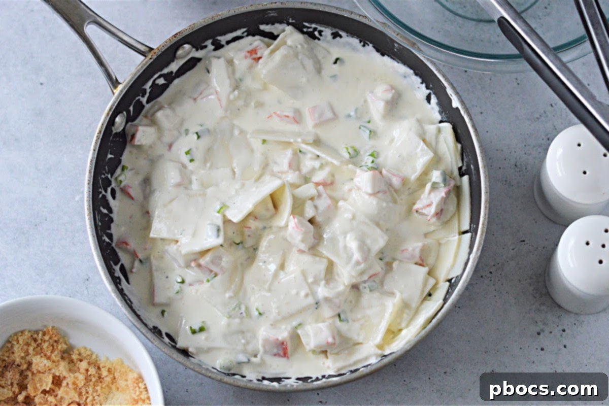 Creamy Keto Crab Rangoon Casserole 12 Crab meat, palmini noodles, and green onions mixed into the sauce