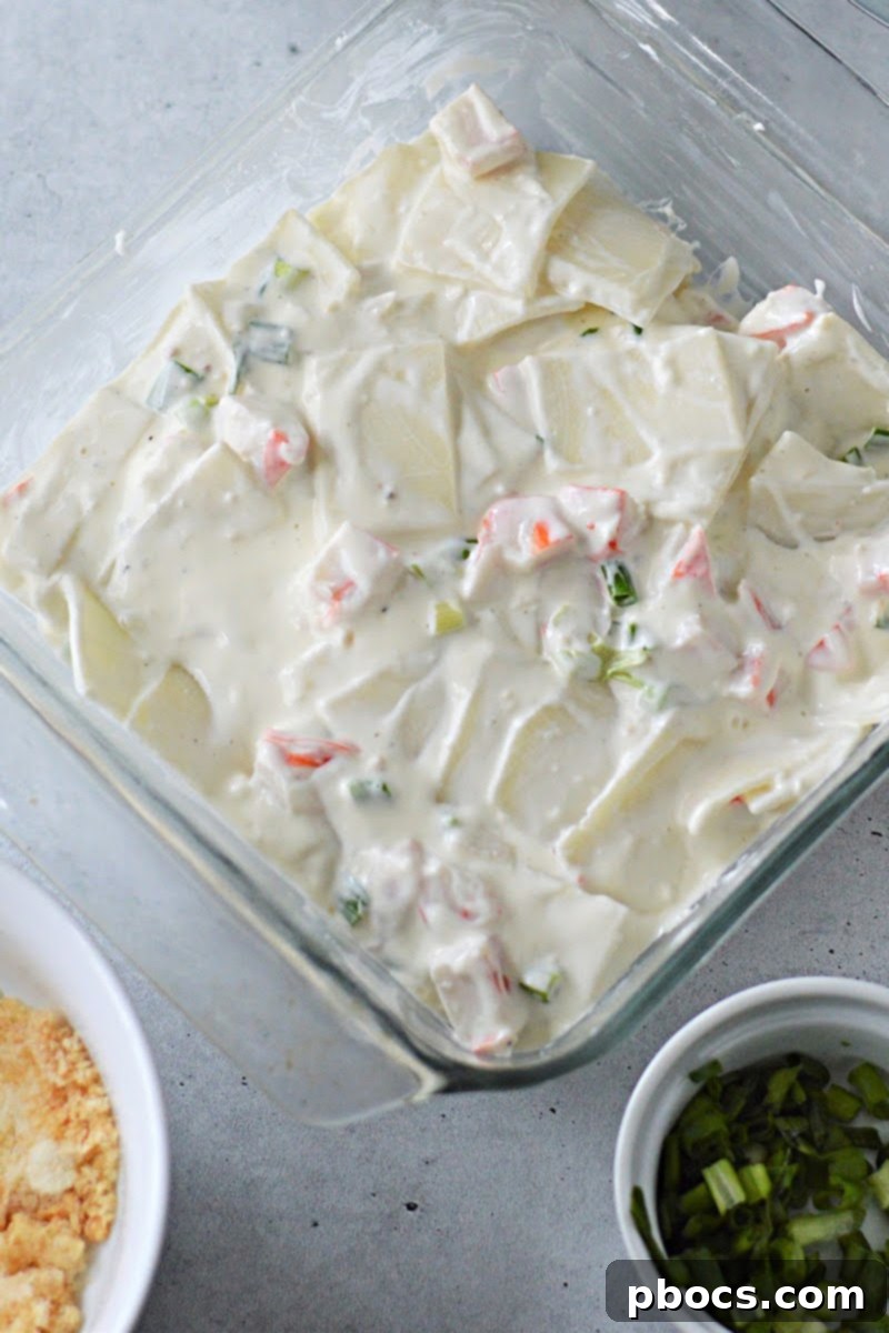 Creamy Keto Crab Rangoon Casserole 13 Casserole mixture spread in baking dish