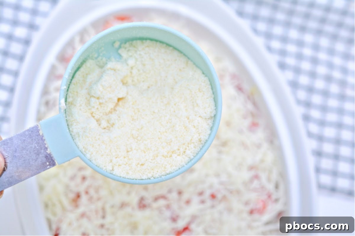 Sprinkling Remaining Parmesan Cheese on Casserole