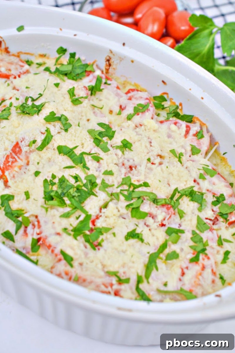 Garnishing Keto Baked Chicken Caprese Casserole with Fresh Basil