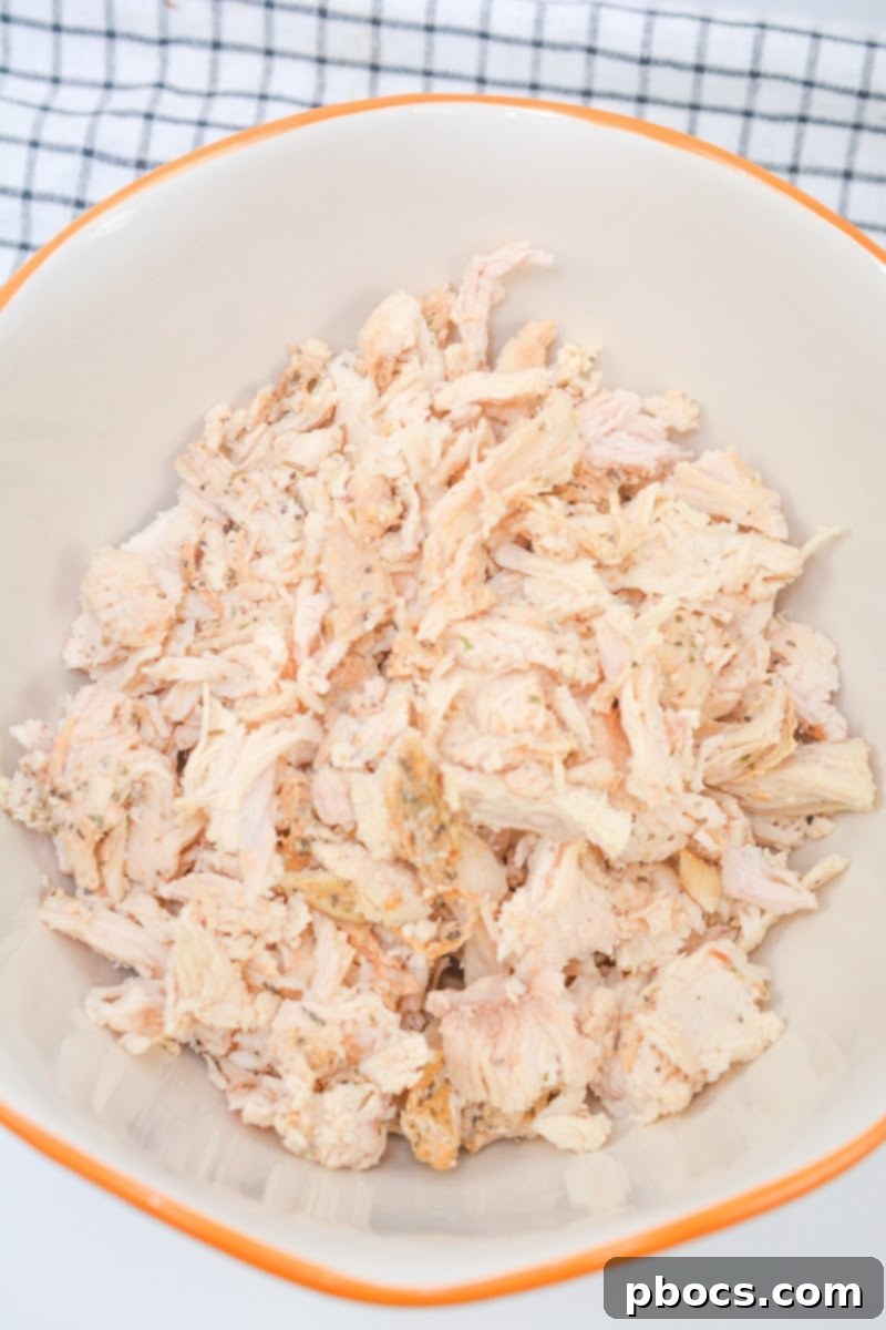 Mixing Ingredients for Keto Baked Chicken Caprese Casserole